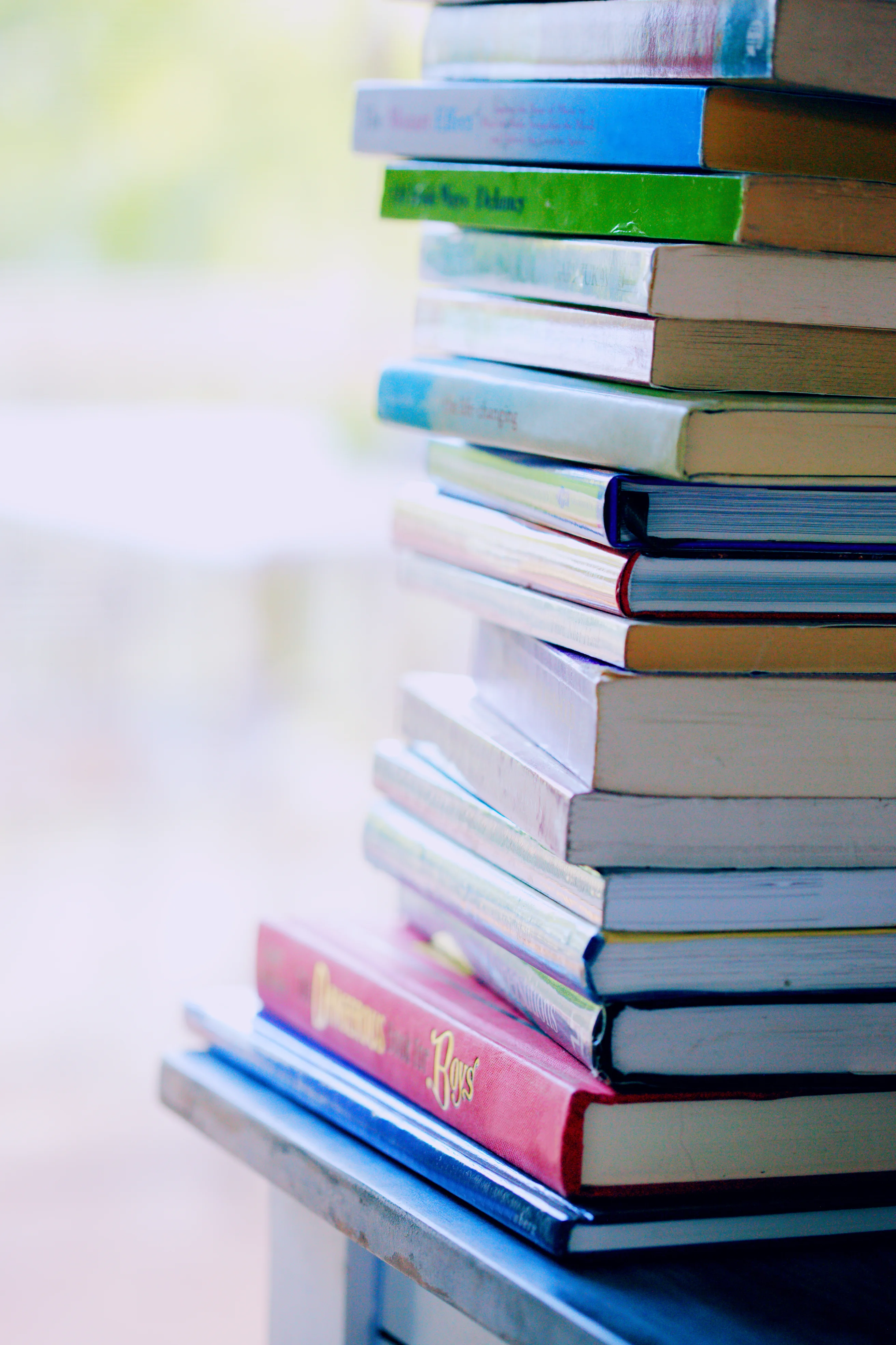 Selective focus photo of pile of assorted title books