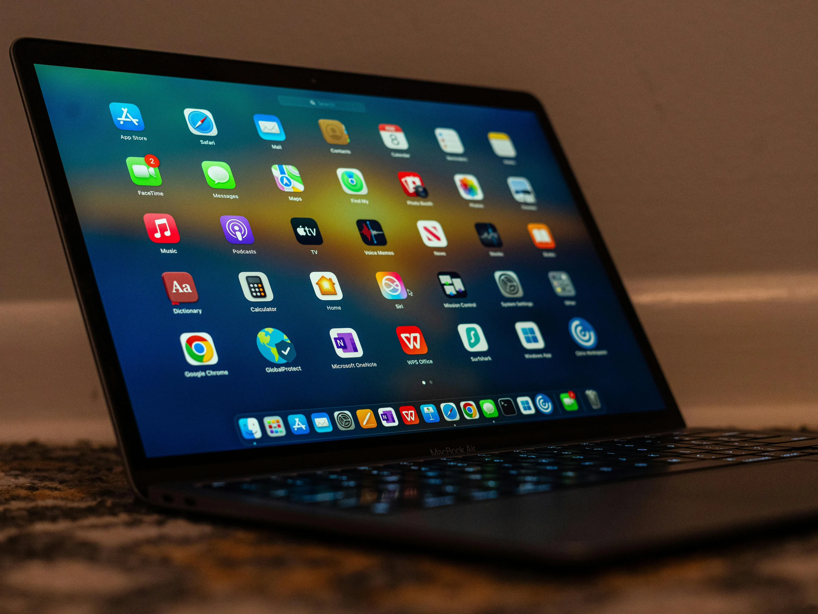 Close-up of a laptop screen showing various applications and colorful icons.