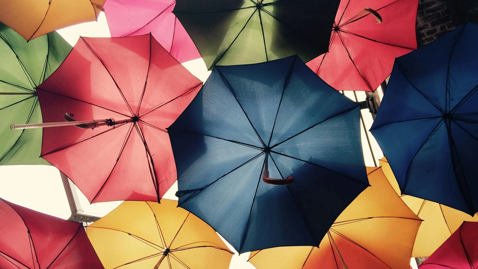 Vibrant umbrellas create a colorful canopy in Greater London, offering protection from sun and rain.