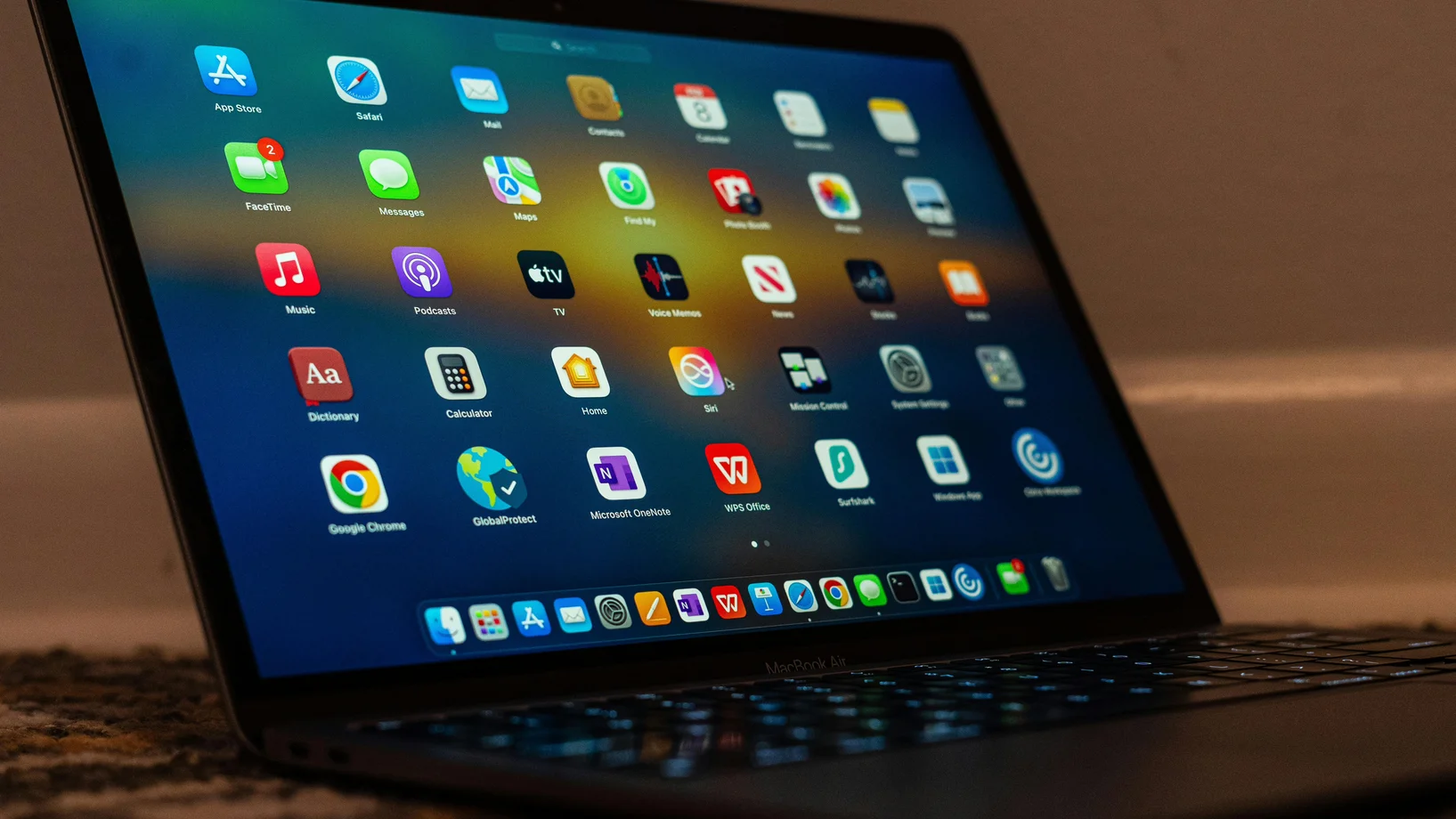 Close-up of a laptop screen showing various applications and colorful icons.